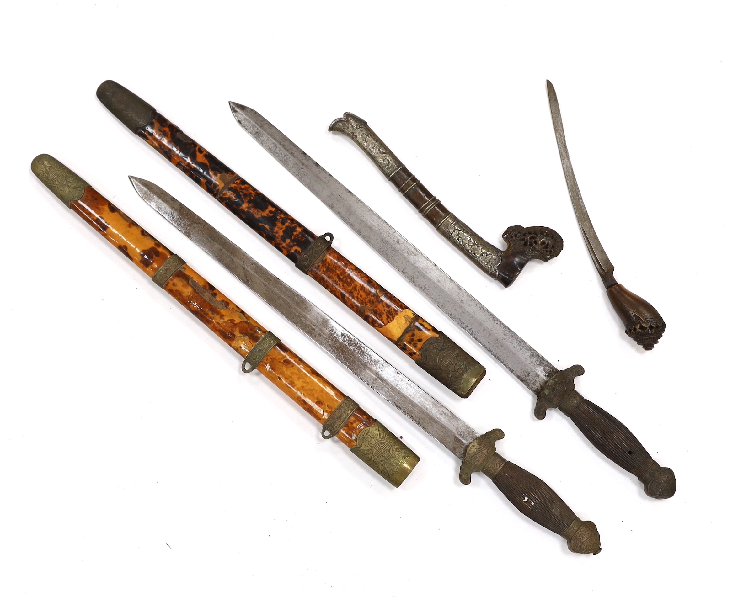 Two Chinese short swords (Jian) in faux tortoiseshell veneered scabbards and a Sumatran knife dagger with sheath (sekin), blade 42cm